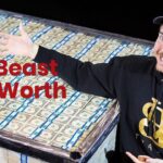 in this image mr beast is standing wearing cap and smiling and showing his money