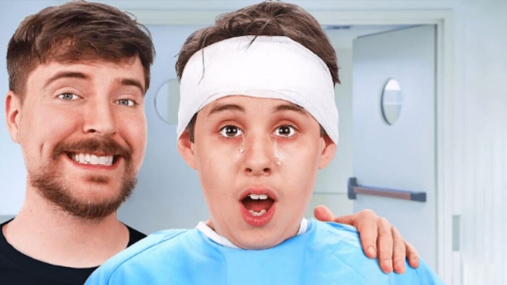 Two individuals with blurred faces: one wearing a blue shirt with a white bandage around their head, the other offering support by placing their hand on the first person’s shoulder. The background shows a door with a small oval window, suggesting an indoor medical setting. Keywords: is mr. beast antichrist